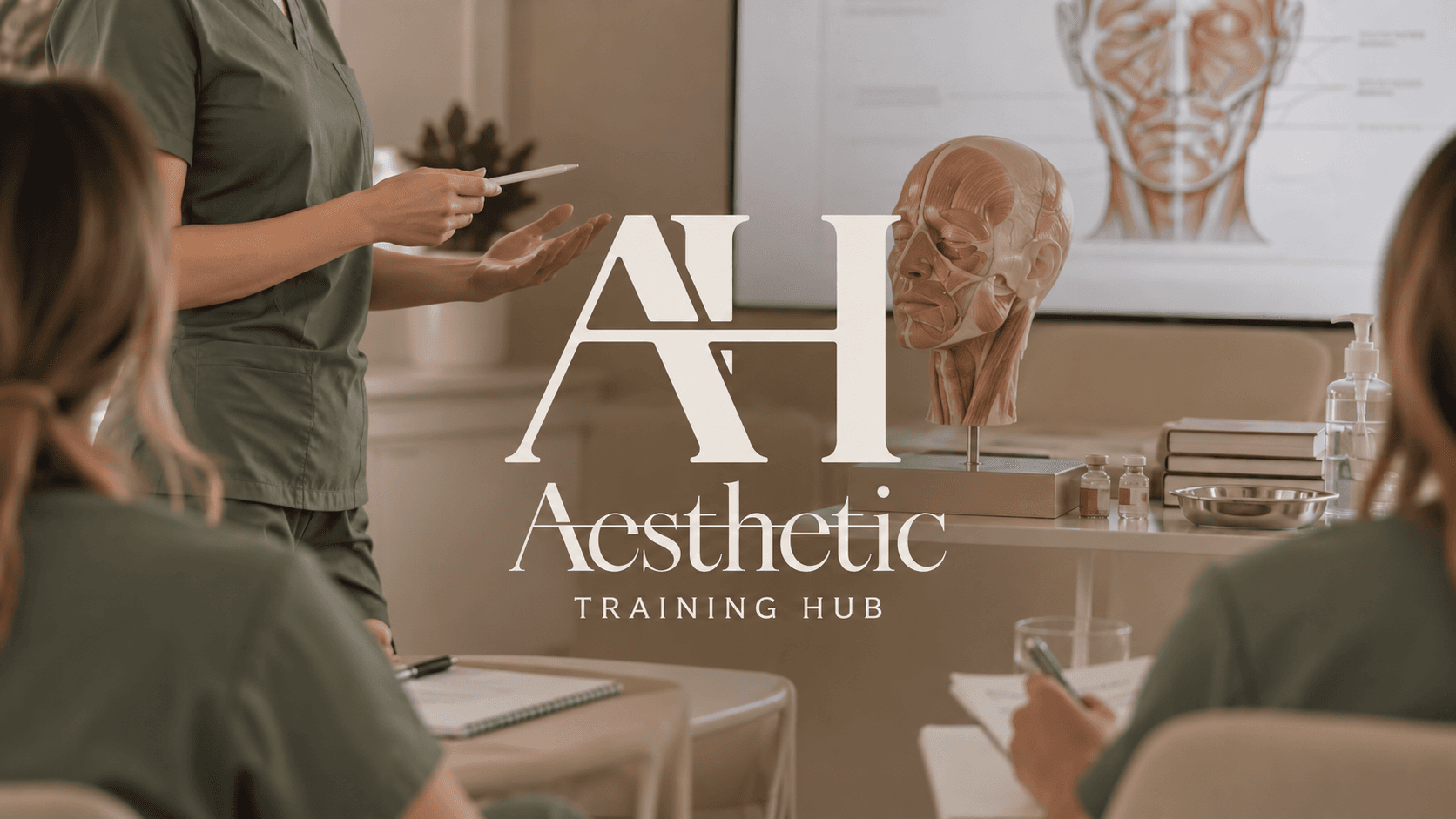 Medical aesthetics educator teaching facial anatomy to healthcare professionals wearing sage green scrubs, with The Aesthetic Training Hub logo overlaid.
